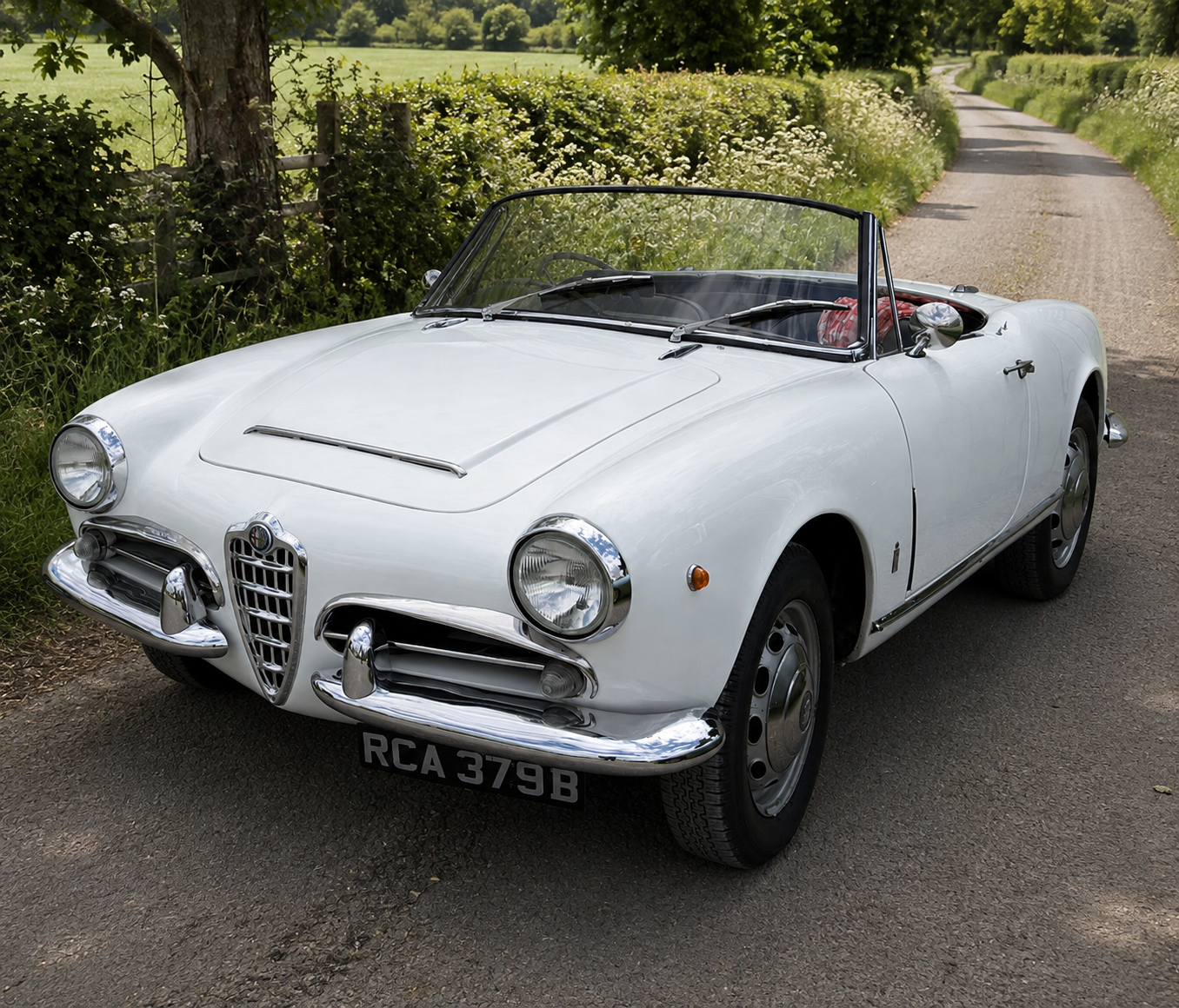 Alfa Romeo Giulia Spider, 101-series Pininfarina bodywork, in white on an English country lane